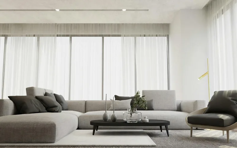 Bright and stylish modern living room interior featuring a chic gray sofa and a sleek coffee table.