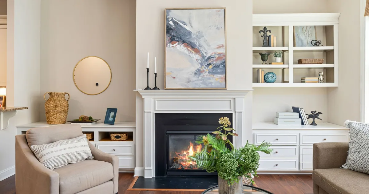 Elegant living room featuring a modern fireplace, art, and stylish furniture for a cozy ambiance.