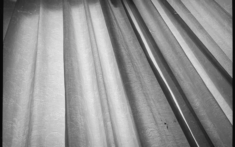 Elegant curtains with intricate patterns in a monochrome aesthetic.