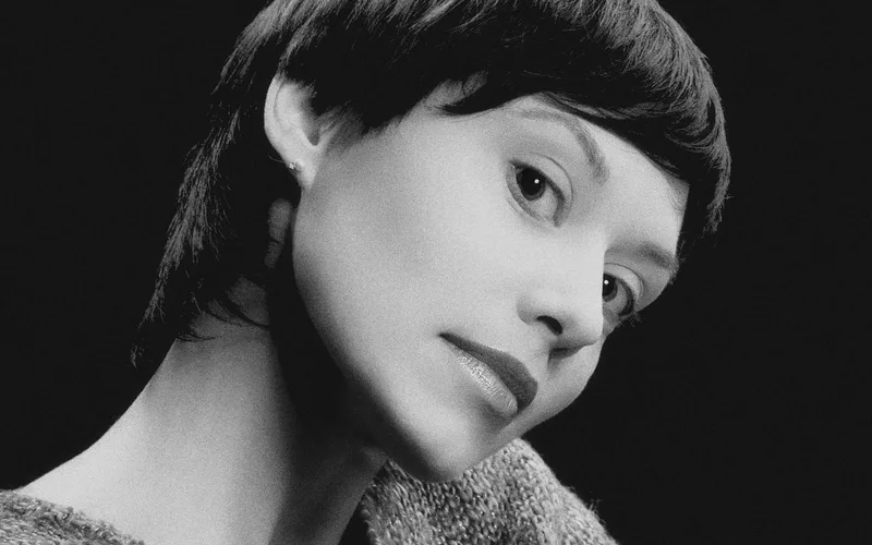 A stunning black and white portrait capturing the elegance of a woman with a classic hairstyle. Perfect for editorial use.