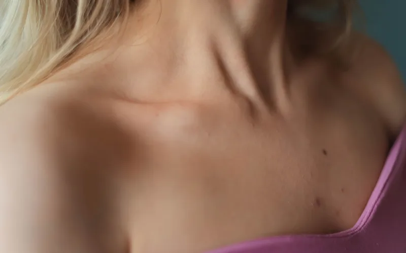 Elegant close-up of a woman's neck and collarbone emphasizing skin detail and fashion.