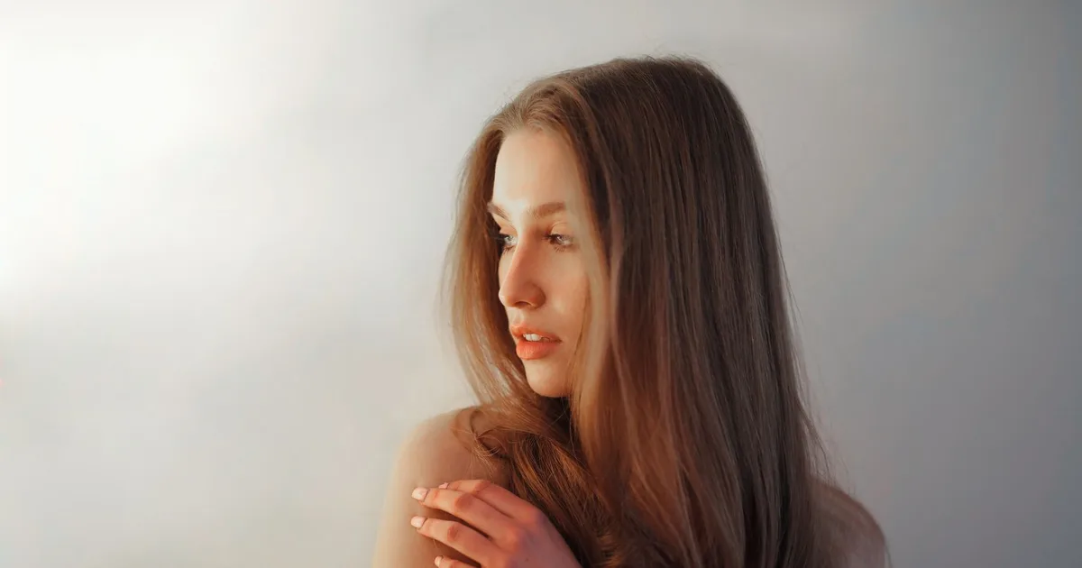 Graceful portrait of a woman looking away, highlighting elegant beauty.